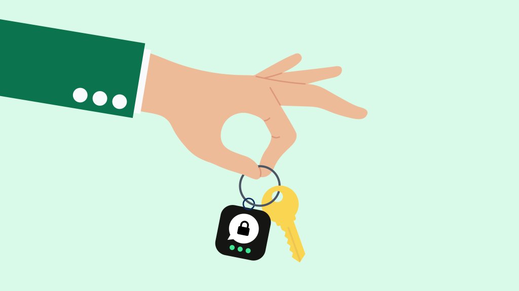 Hand holding a keyring with a key and the Threema icon.