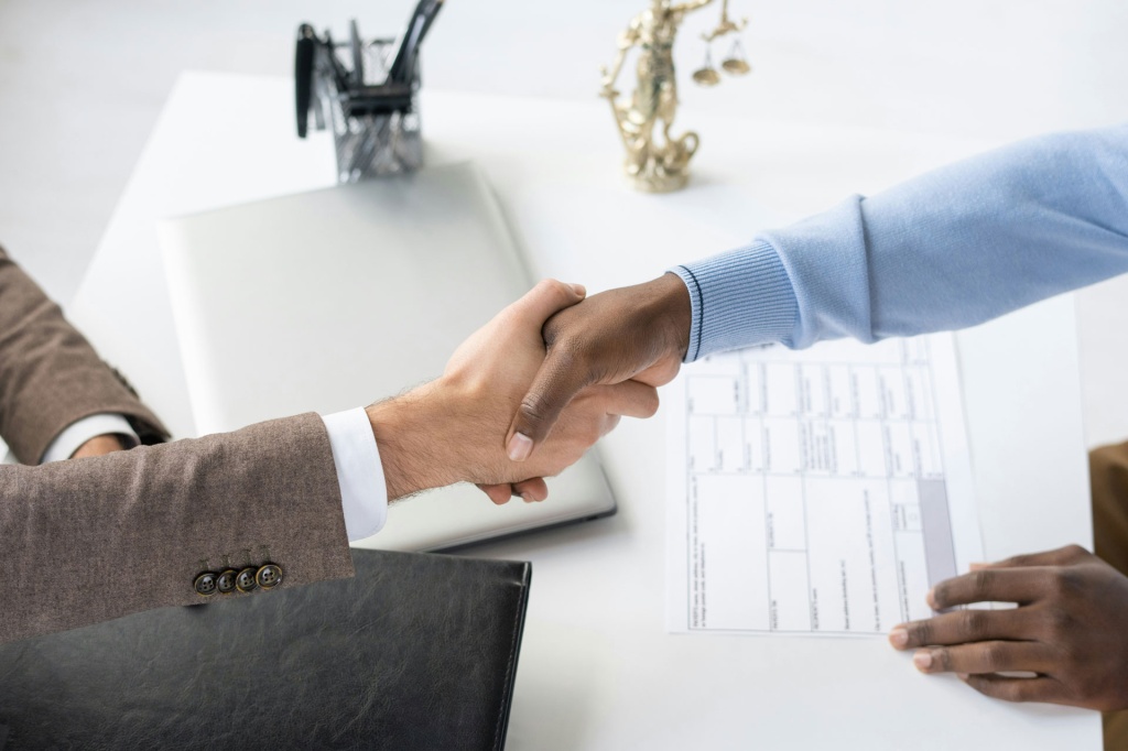Two people shake hands.