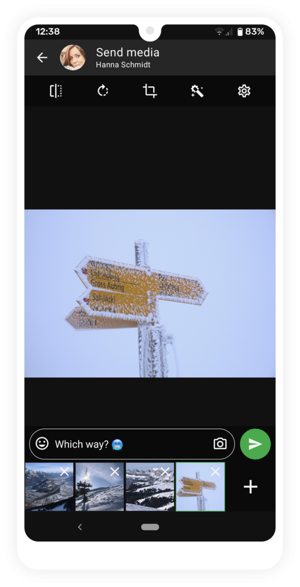 Photo of a snow-covered yellow mountain trail signpost against a gray sky.